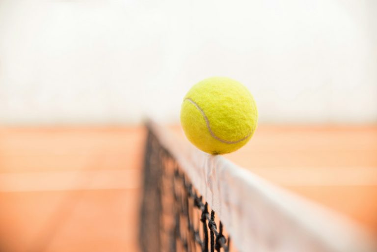 Tennis ball on the net